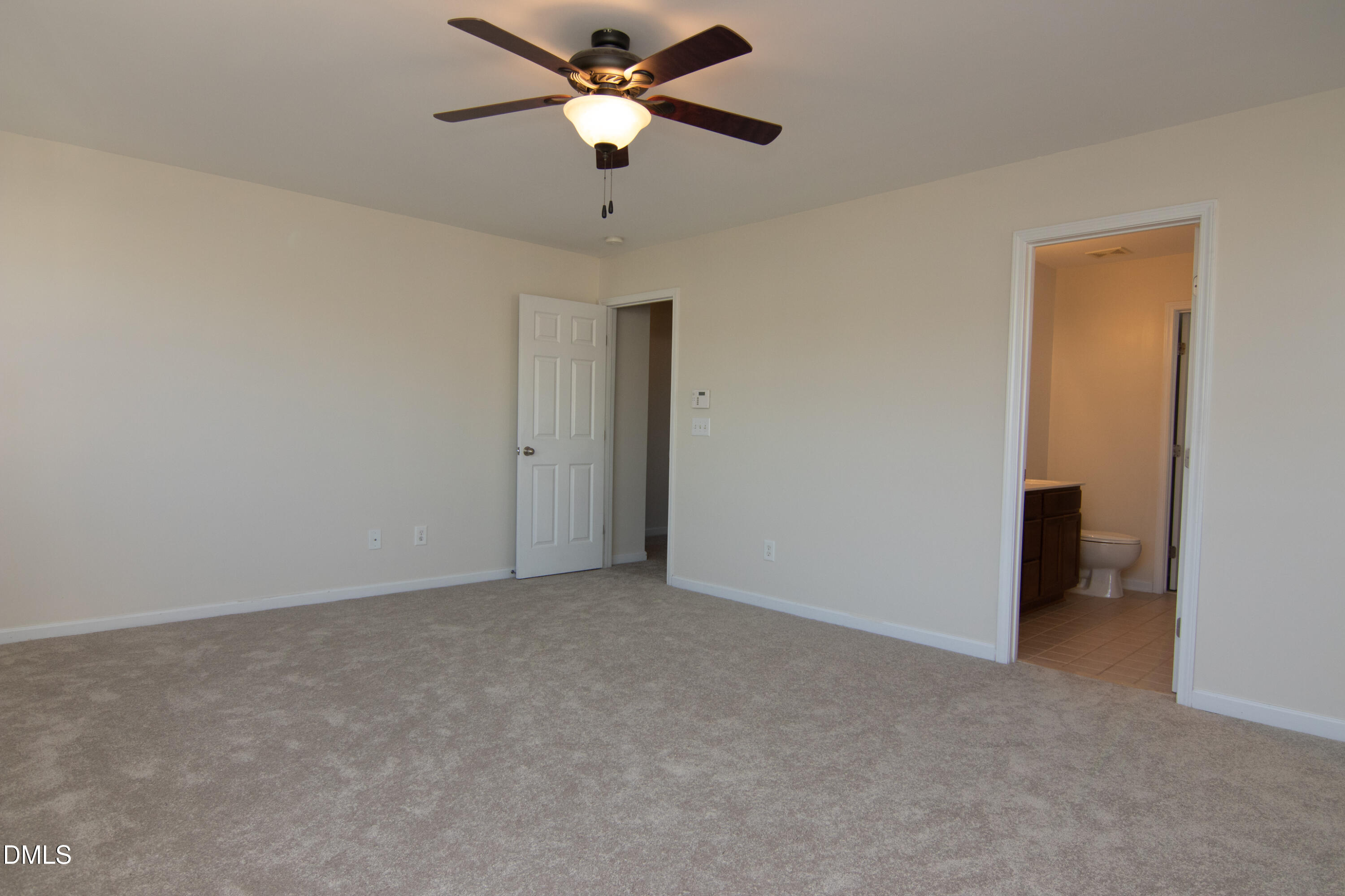 9903 Grettle Court Raleigh, NC 27617 - Photo 21 of 40 an empty room with closet and a chandelier fan