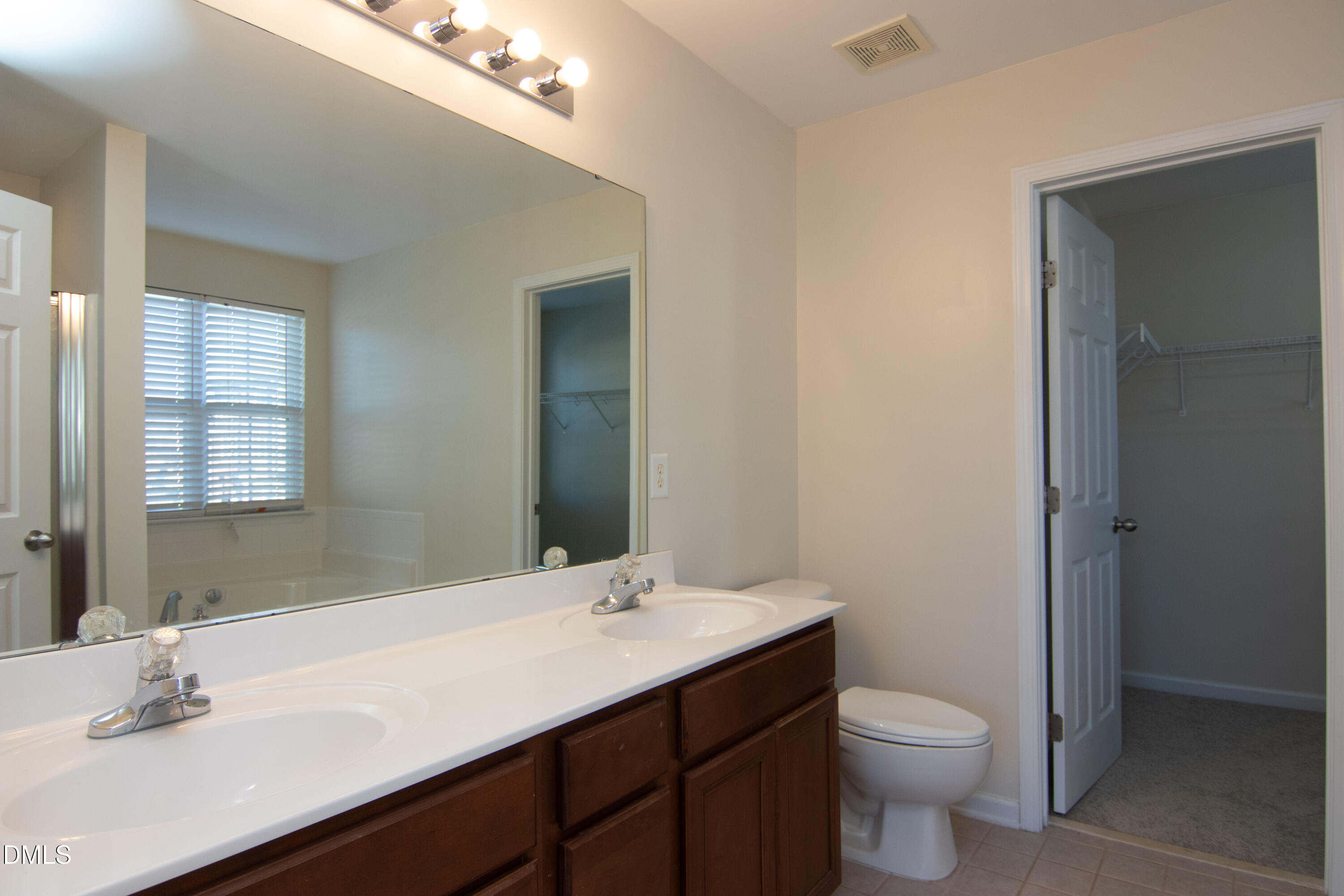 9903 Grettle Court Raleigh, NC 27617 - Photo 23 of 40 a bathroom with a sink toilet and a mirror