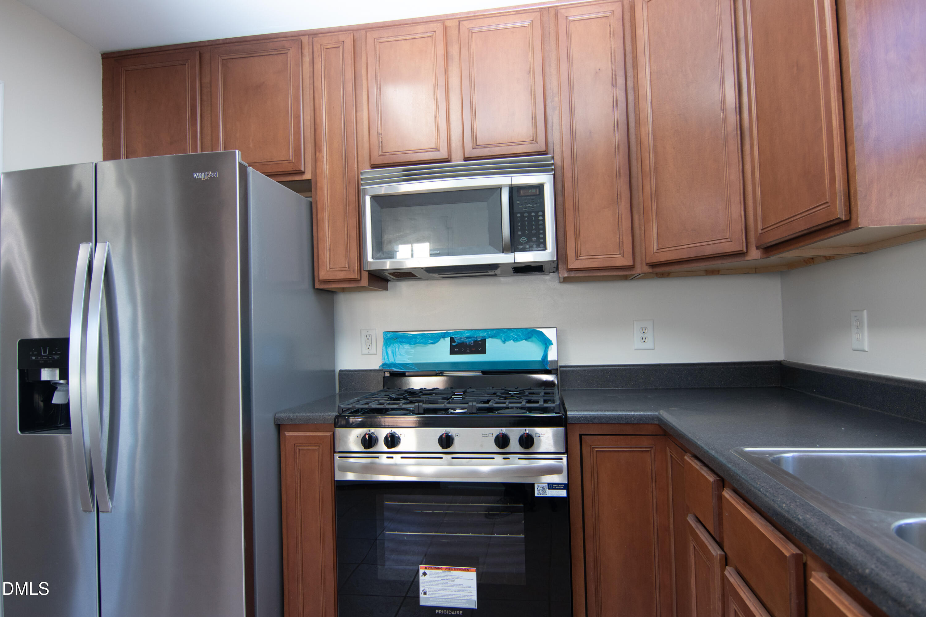 9903 Grettle Court Raleigh, NC 27617 - Photo 4 of 40 a kitchen with stainless steel appliances granite countertop a refrigerator stove and microwave