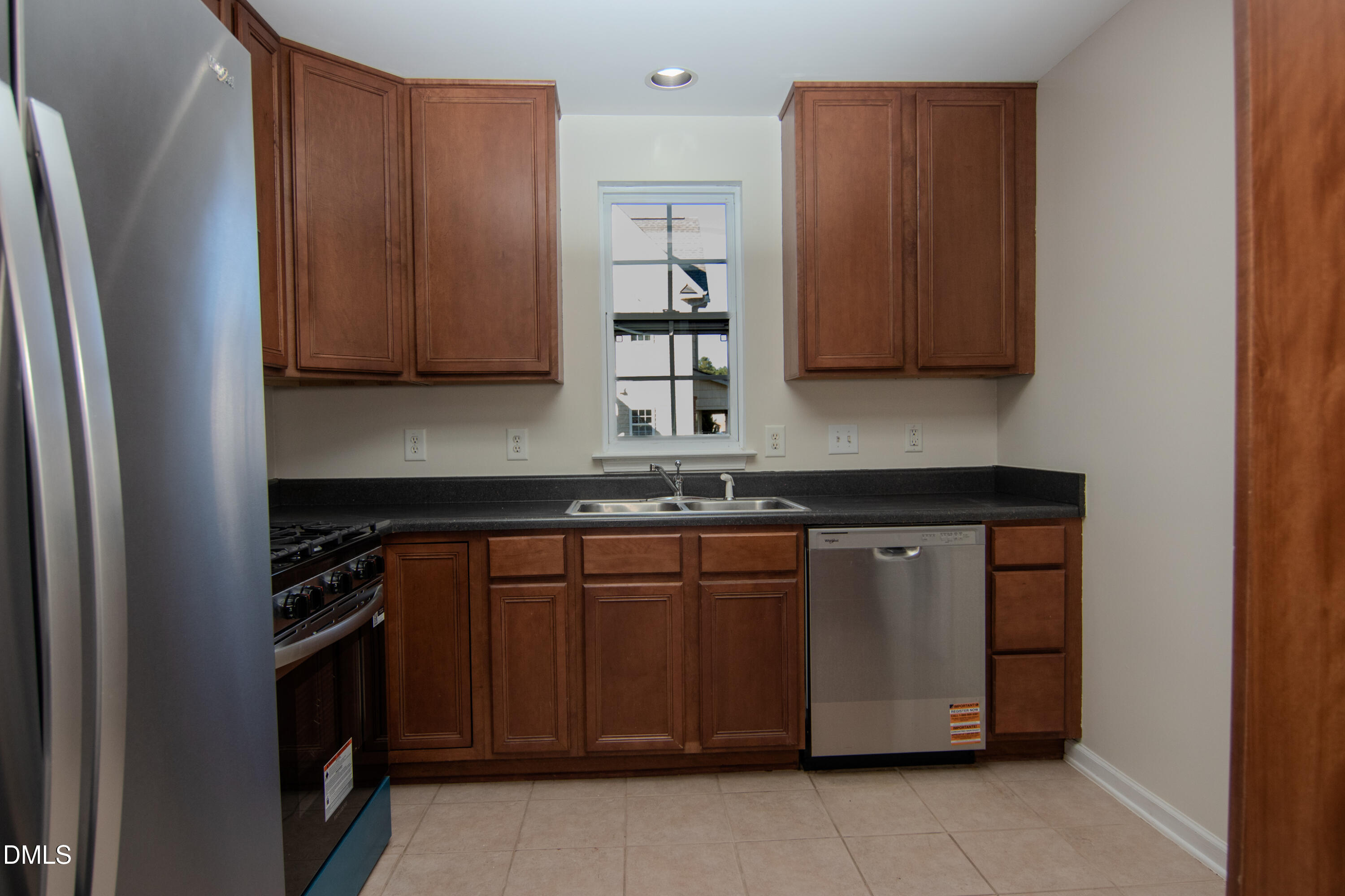 9903 Grettle Court Raleigh, NC 27617 - Photo 6 of 40 a kitchen with stainless steel appliances granite countertop a refrigerator and a stove top oven