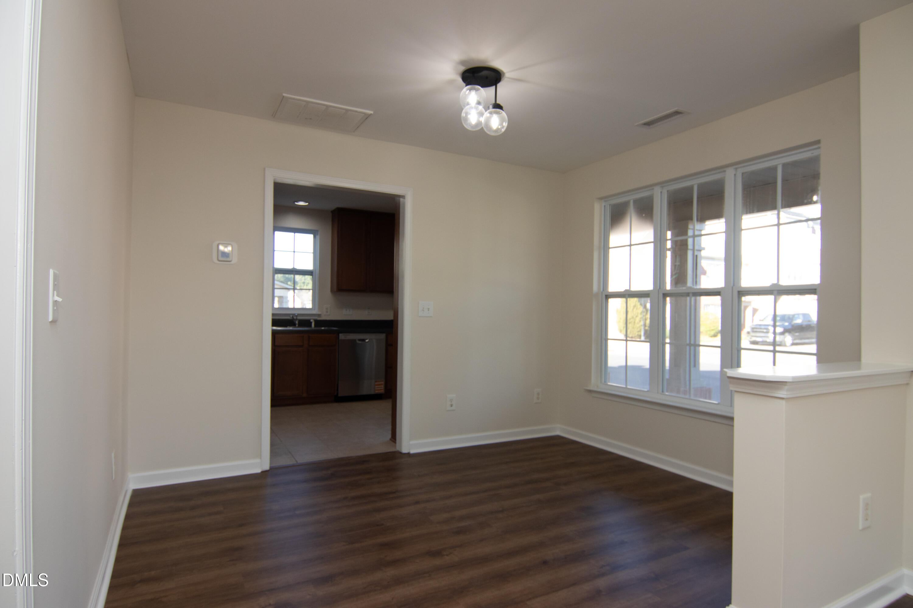 9903 Grettle Court Raleigh, NC 27617 - Photo 7 of 40 an empty room with wooden floor and windows