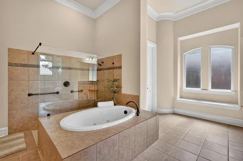 a bathroom with a bathtub and shower