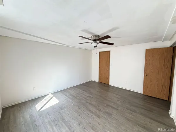 a view of empty room with wooden floor
