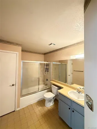 a bathroom with a granite countertop sink mirror toilet and shower