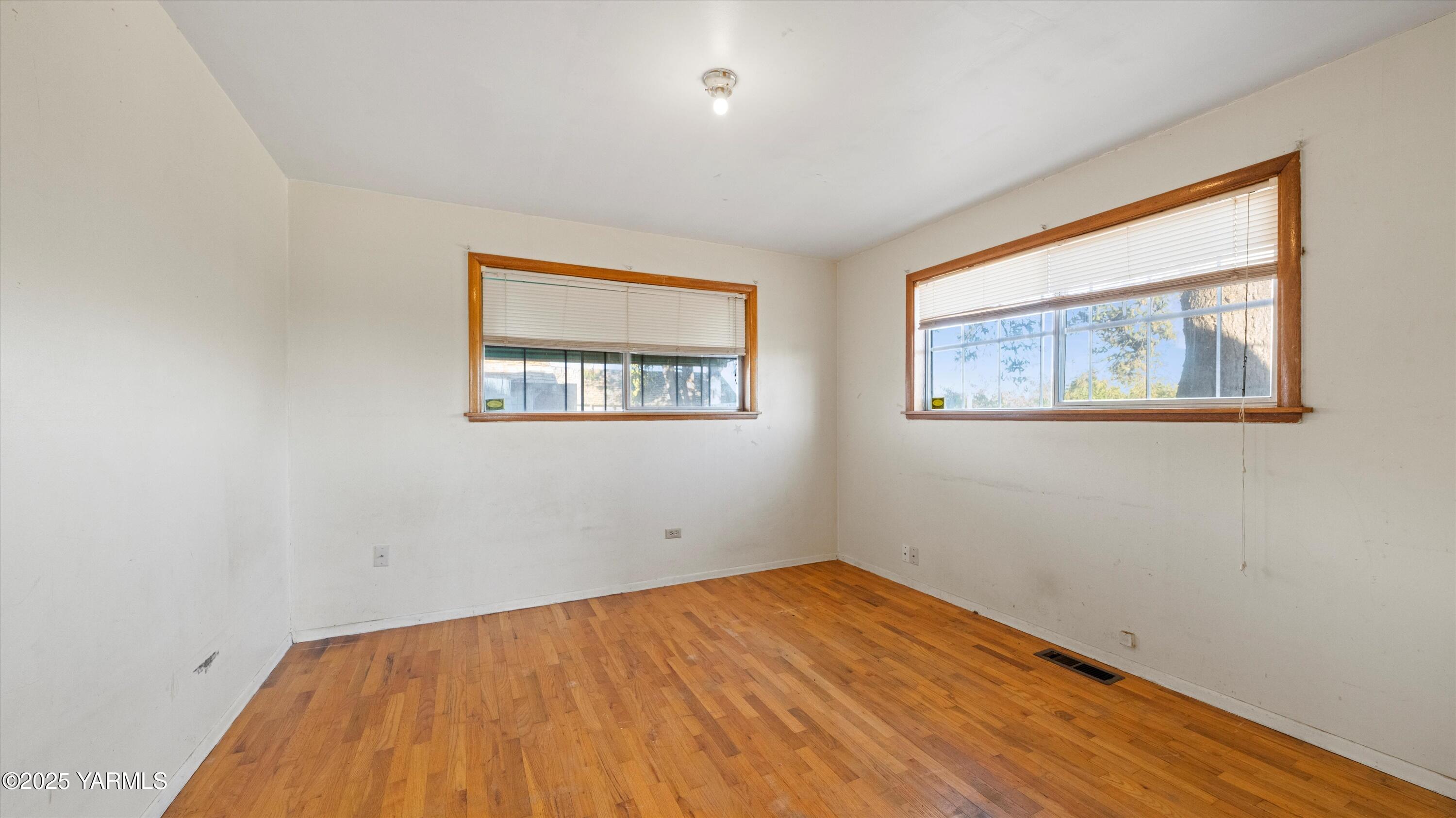 2284 Ashue Road Wapato, WA 98951 - Photo 8 of 25 a view of empty room with wooden floor and fan