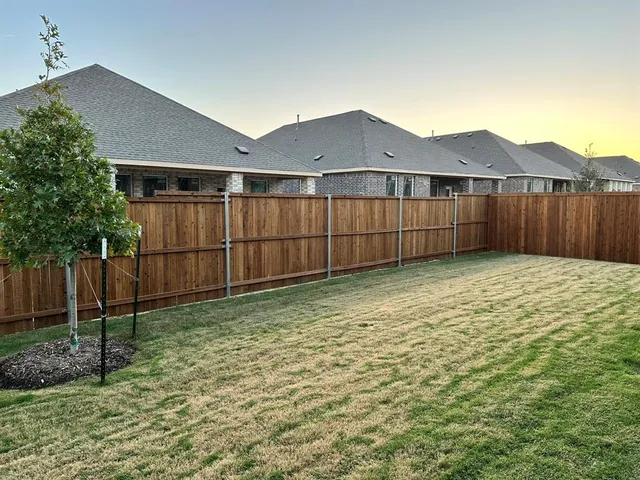 a kitchen with stainless steel appliances granite countertop a sink dishwasher and a stove with wooden floor
