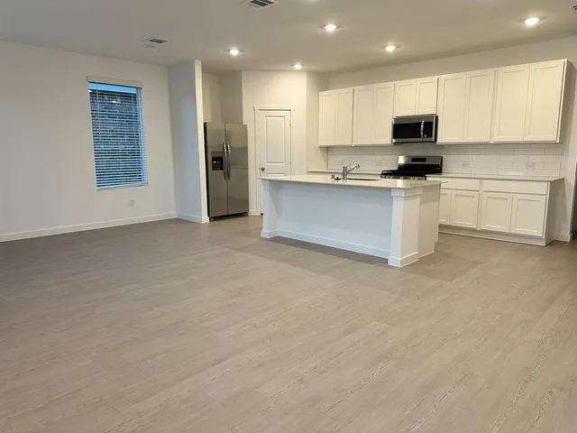 a view of a lake with table and chairs under an umbrella