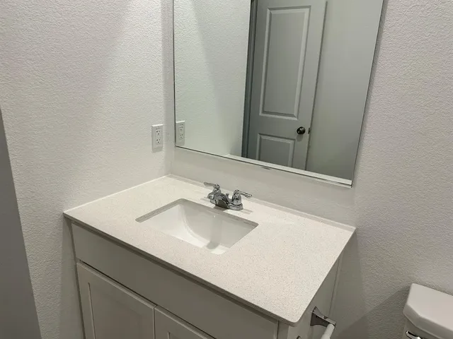 a bathroom with a toilet a sink and bathtub