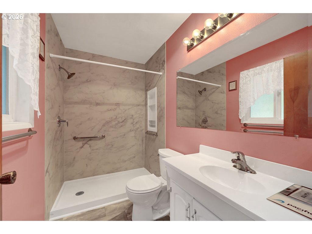 1415 20th Street Florence, OR 97439 - Photo 20 of 40 a bathroom with a sink a toilet and shower