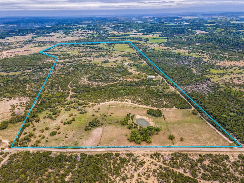 a view of a pool with a lawn chairs