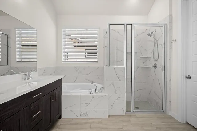 a bathroom with a granite countertop sink a toilet and shower