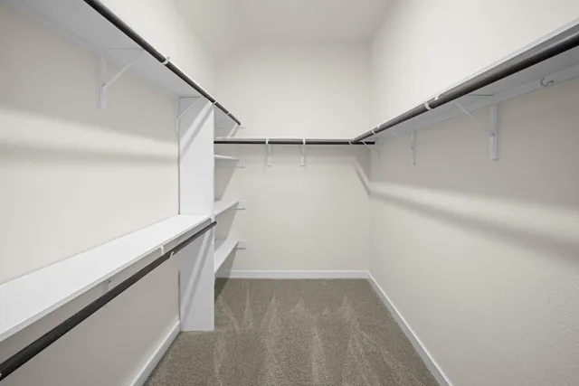 a view of walk in closet with wooden floor