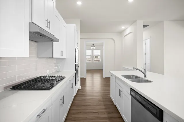 a kitchen with granite countertop a sink and stove