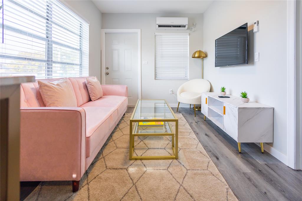 140 Northeast 71st Street, Unit 1 Miami, FL 33138 - Photo 1 of 18 a living room with a couch and a flat screen tv