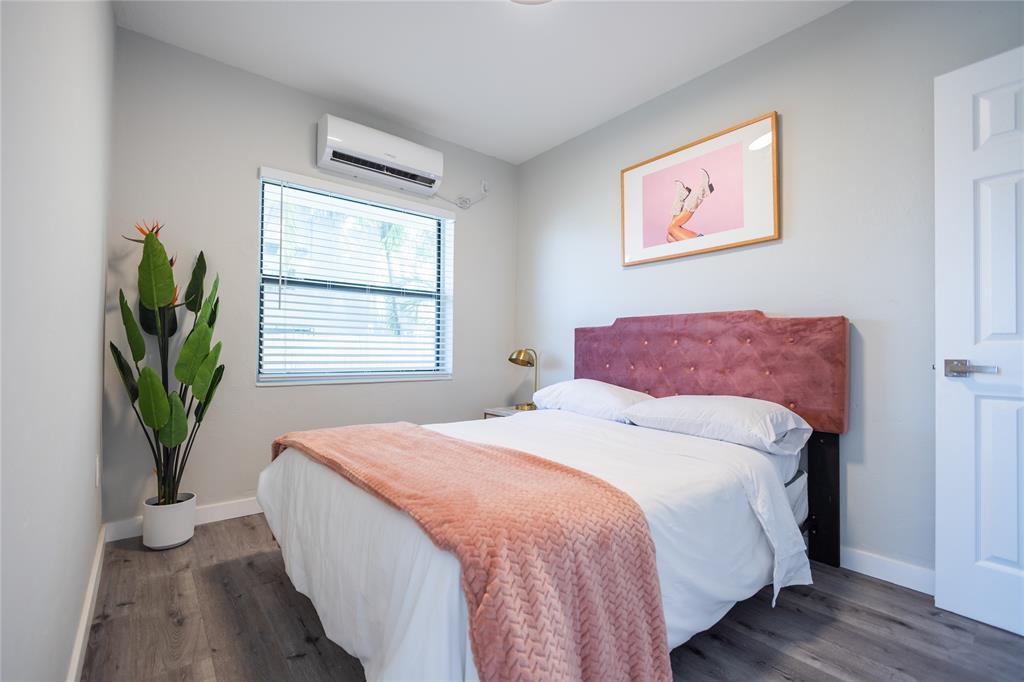 140 Northeast 71st Street, Unit 1 Miami, FL 33138 - Photo 11 of 18 a bedroom with bed and a potted plant