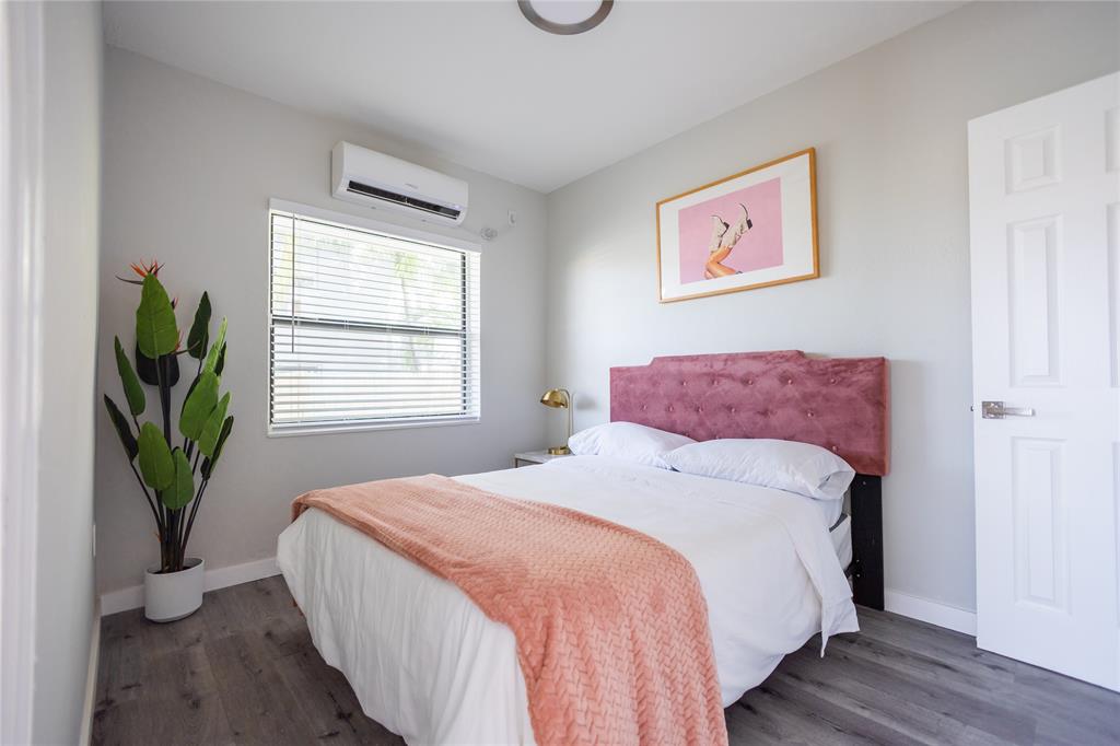 140 Northeast 71st Street, Unit 1 Miami, FL 33138 - Photo 12 of 18 a bedroom with a bed and a potted plant
