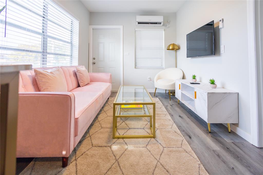 140 Northeast 71st Street, Unit 1 Miami, FL 33138 - Photo 2 of 18 a living room with a couch and a flat screen tv