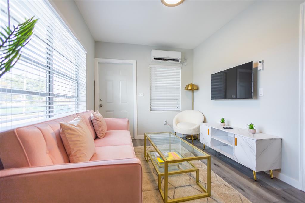 140 Northeast 71st Street, Unit 1 Miami, FL 33138 - Photo 4 of 18 a living room with furniture and a flat screen tv