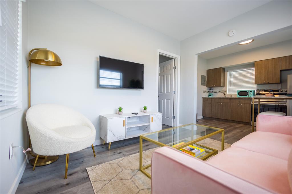 140 Northeast 71st Street, Unit 1 Miami, FL 33138 - Photo 5 of 18 a living room with furniture and a flat screen tv