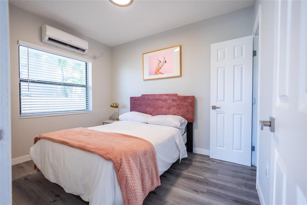 140 Northeast 71st Street, Unit 1 Miami, FL 33138 - Photo 9 of 18 a bedroom with a bed and wooden floor