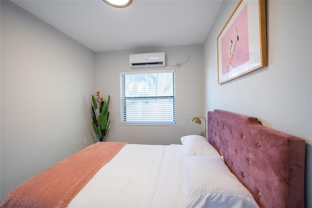 140 Northeast 71st Street, Unit 1 Miami, FL 33138 - Photo 10 of 18 a bedroom with a bed and a window