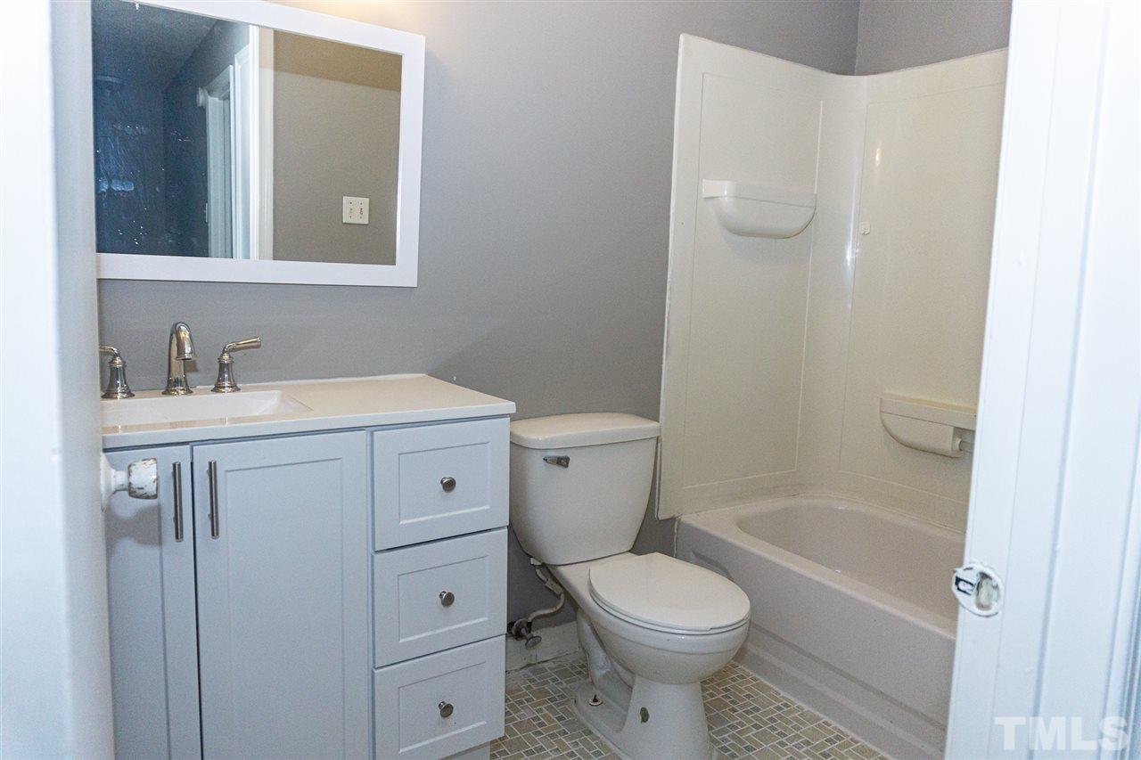 4311 Lake Ridge Drive, Unit 4311 Raleigh, NC 27604 - Photo 14 of 15 a bathroom with a sink a toilet and shower