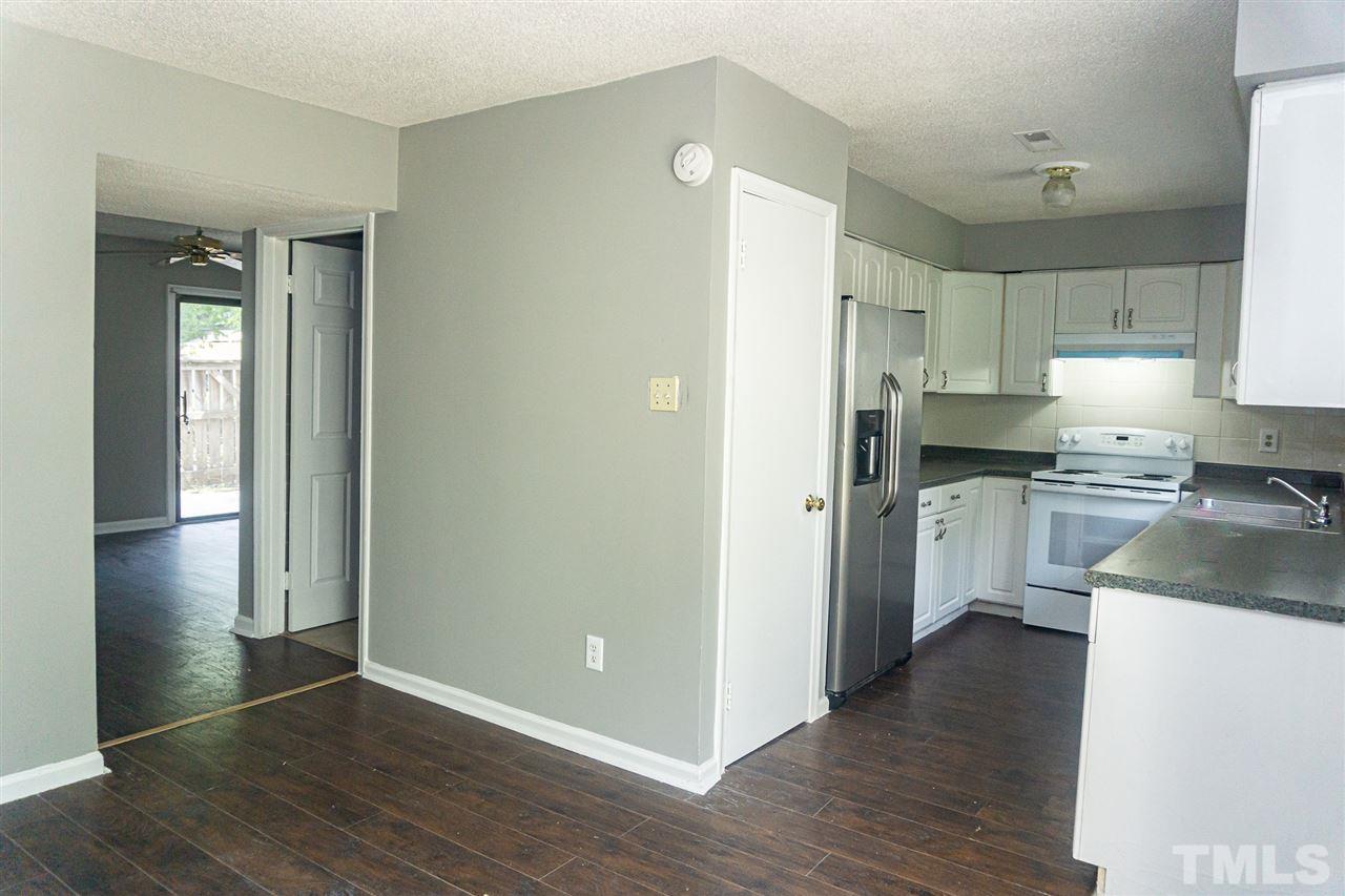 4311 Lake Ridge Drive, Unit 4311 Raleigh, NC 27604 - Photo 3 of 15 a kitchen with granite countertop white cabinets and stainless steel appliances