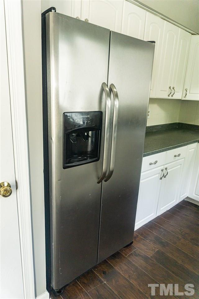 4311 Lake Ridge Drive, Unit 4311 Raleigh, NC 27604 - Photo 4 of 15 a kitchen with a refrigerator and cabinets