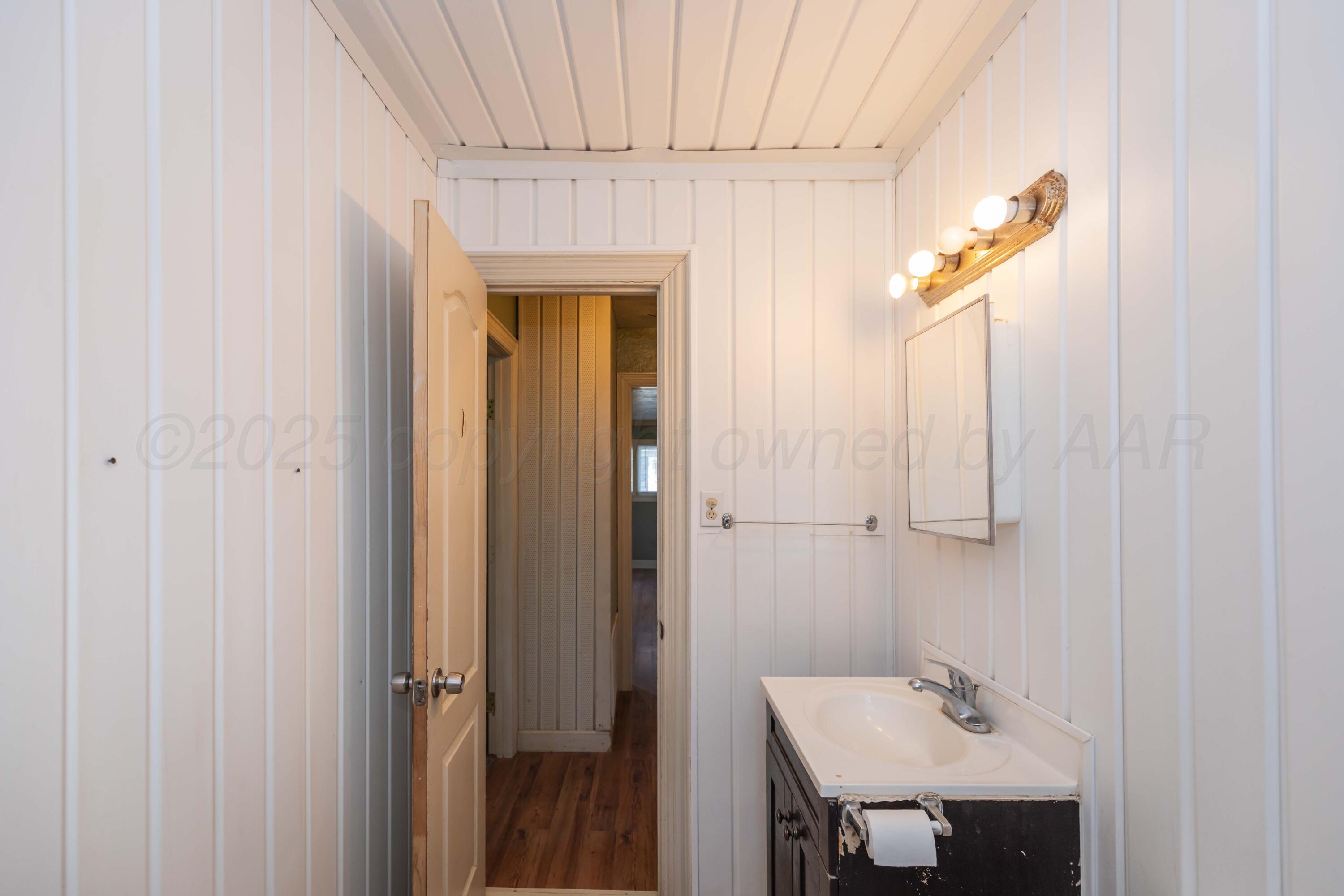 4209 South Lipscomb Street Amarillo, TX 79110 - Photo 20 of 31 a bathroom with a sink and mirror