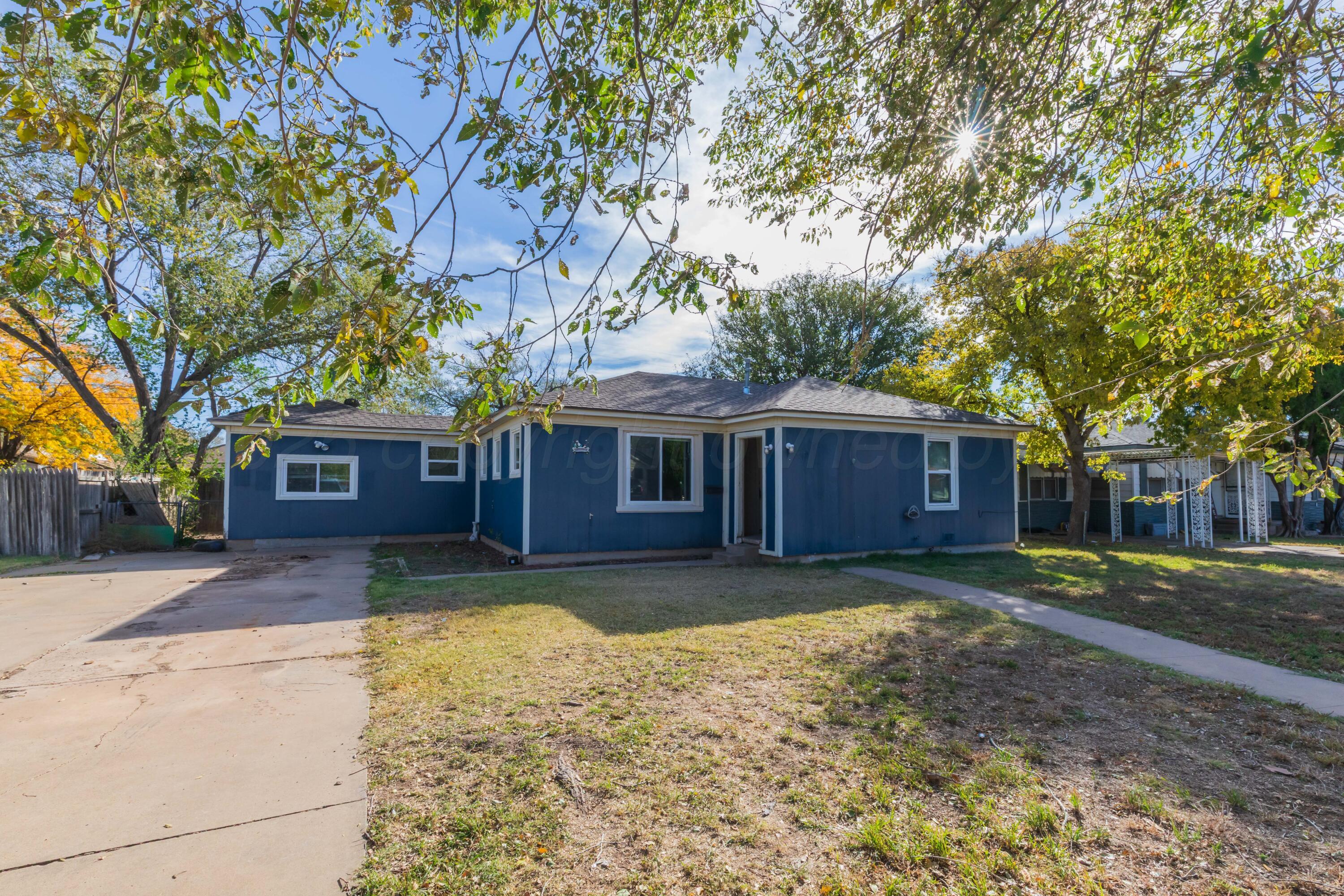 4209 South Lipscomb Street Amarillo, TX 79110 - Photo 2 of 31 a view of a yard in front of a house with large tree