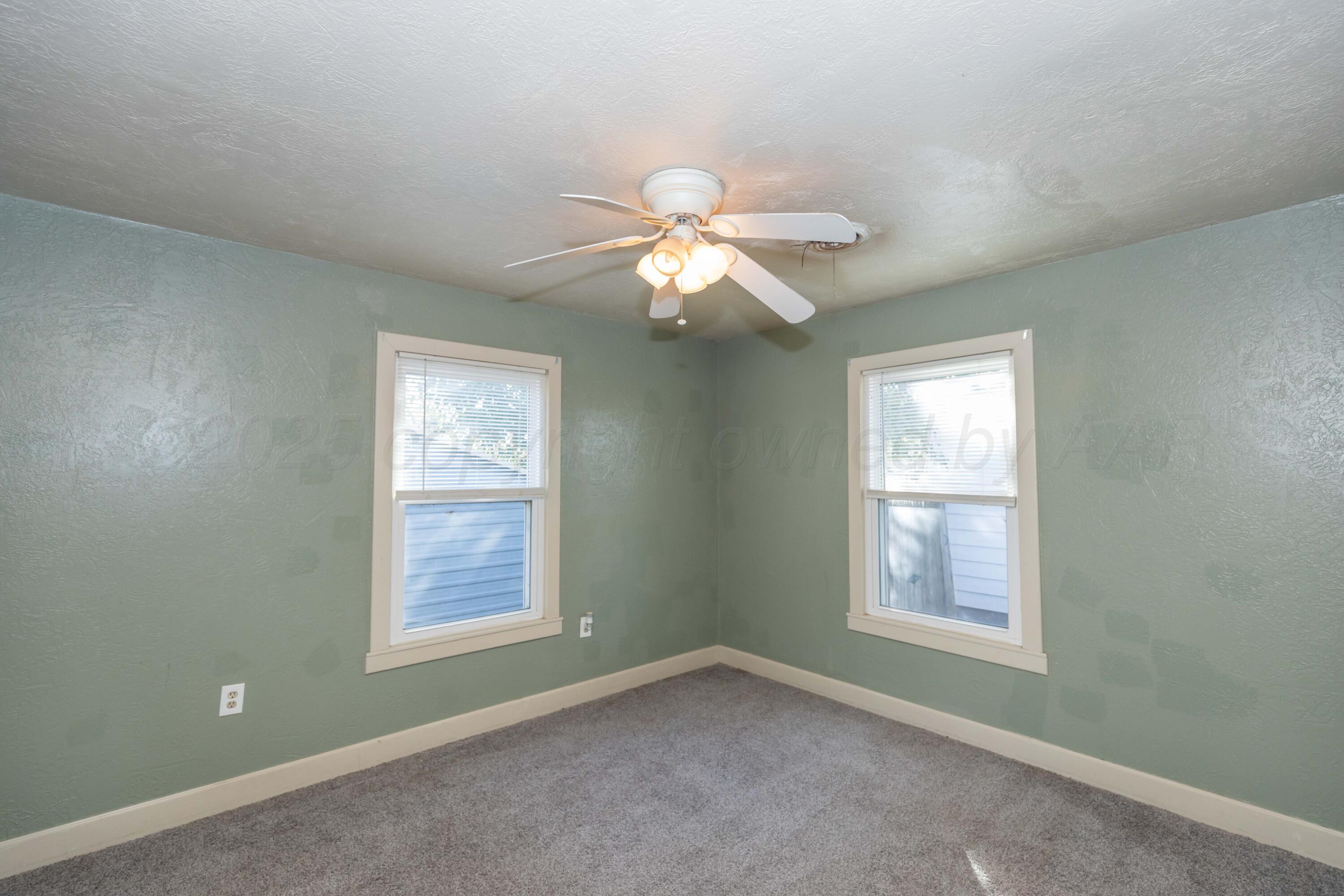 4209 South Lipscomb Street Amarillo, TX 79110 - Photo 21 of 31 a view of a room that has a window and a chandelier fan