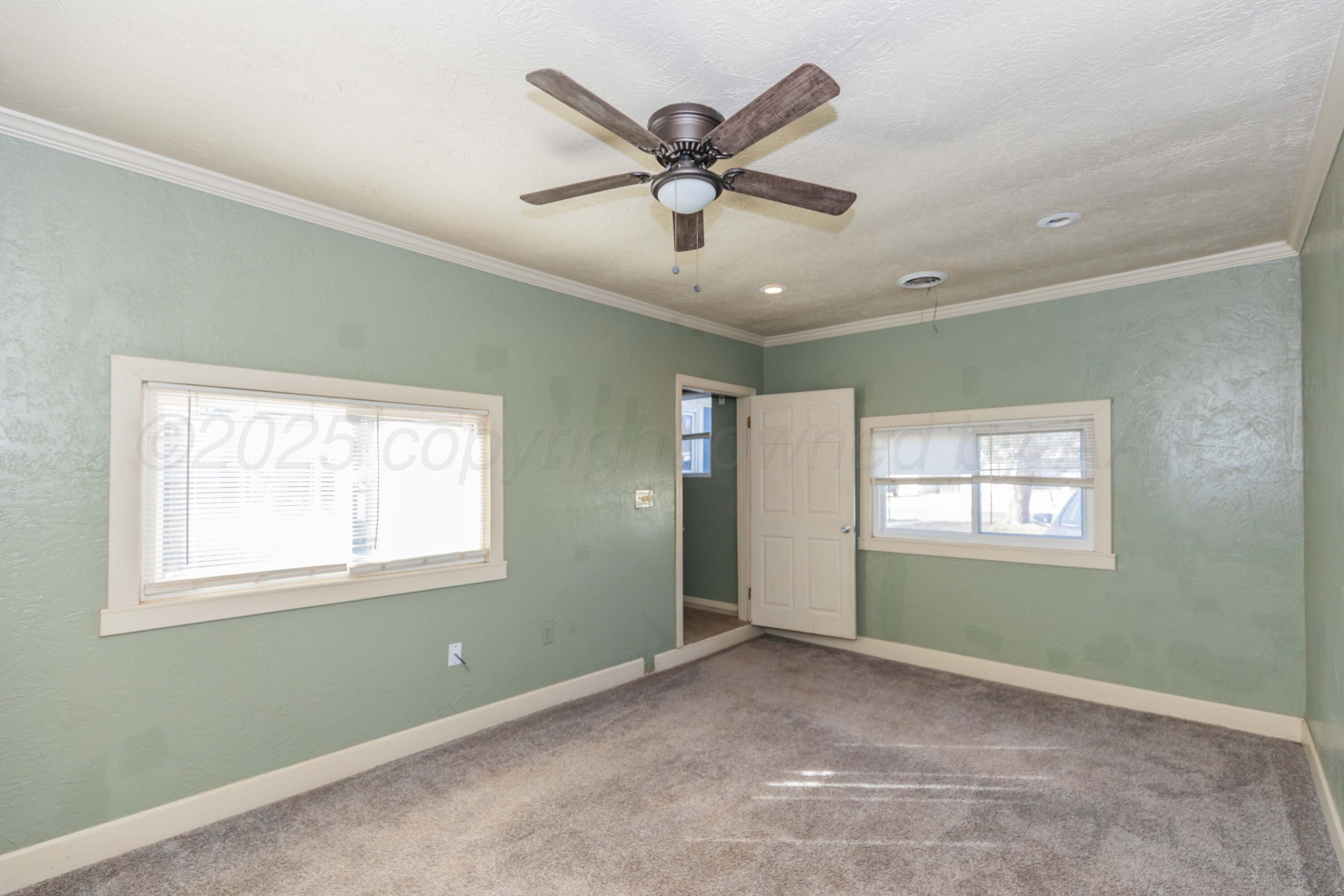 4209 South Lipscomb Street Amarillo, TX 79110 - Photo 27 of 31 a view of an empty room with window and ceiling fan