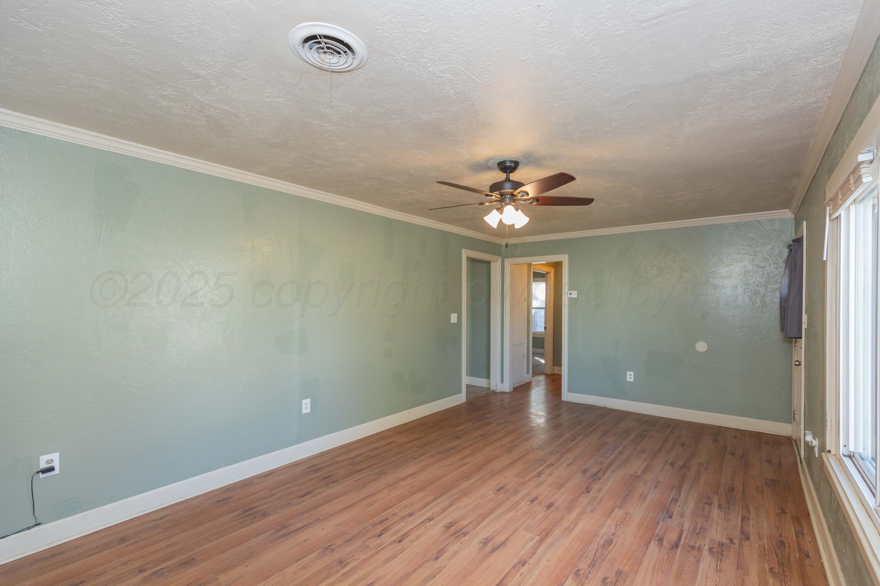 4209 South Lipscomb Street Amarillo, TX 79110 - Photo 7 of 31 wooden floor in an empty room with a window