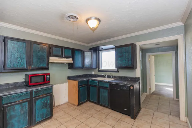 a kitchen with stainless steel appliances granite countertop a stove sink and cabinets