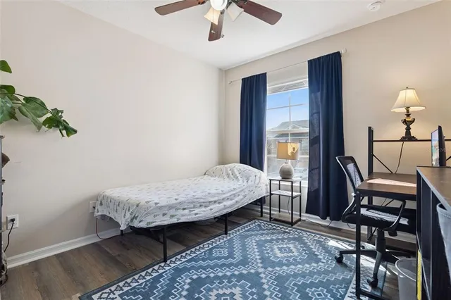 a bedroom with a bed window and a chandelier