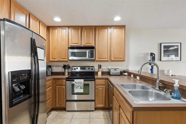 a kitchen with kitchen island granite countertop a sink stainless steel appliances and counter space