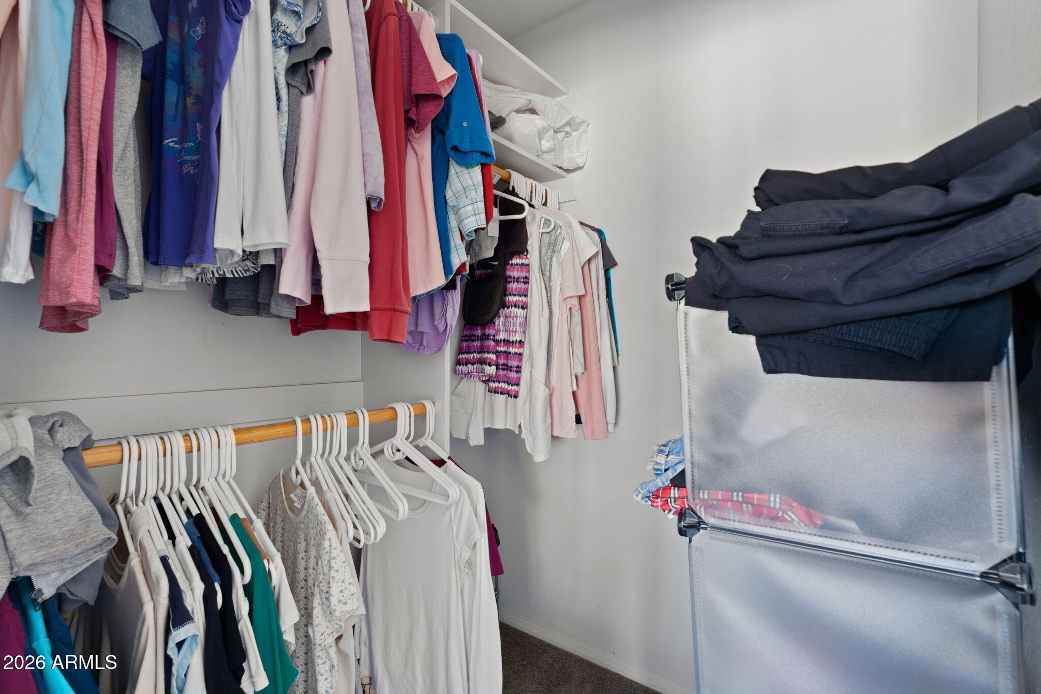 27144 Bennett Way Congress, AZ 85332 - Photo 12 of 33 a view of walk in closet with clothes and shoes