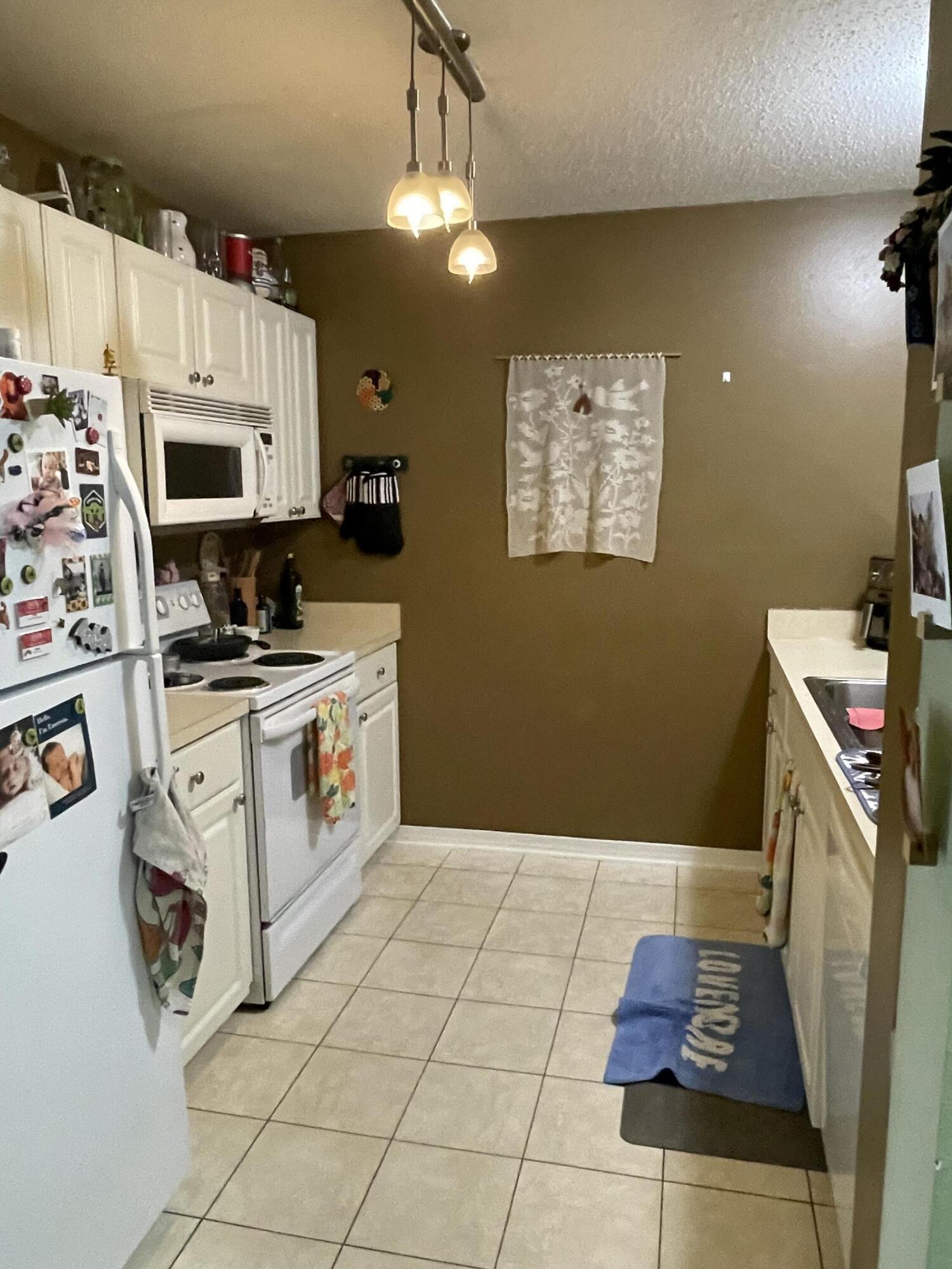 468 Keystone Road, Unit 468 Mary Esther, FL 32569 - Photo 6 of 15 a kitchen with a white stove top oven and cabinets
