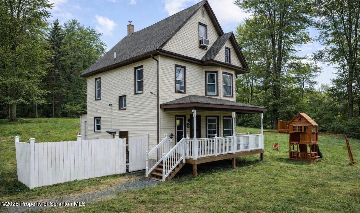 an aerial view of a house with a garden and deck