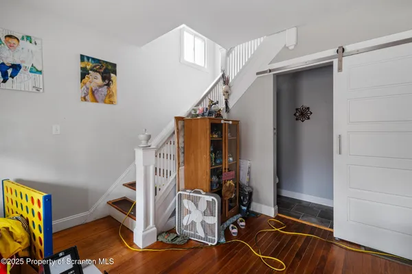 a view of a room with wooden floor and front door