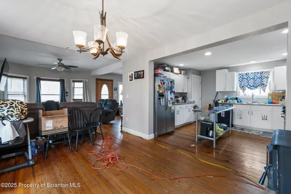 a kitchen with stainless steel appliances granite countertop a refrigerator a stove and a sink