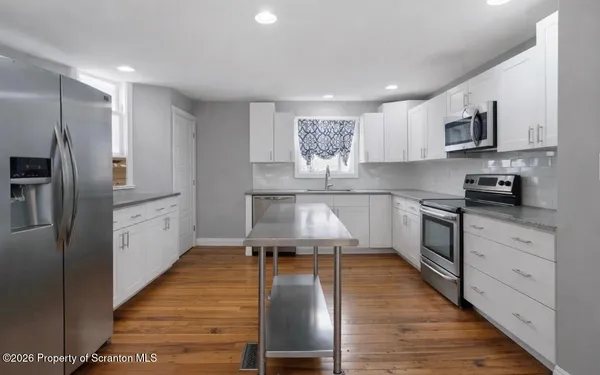 a kitchen with sink a stove and cabinets