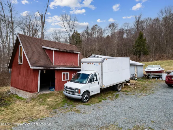 a view of a house with a truck parked in a yard