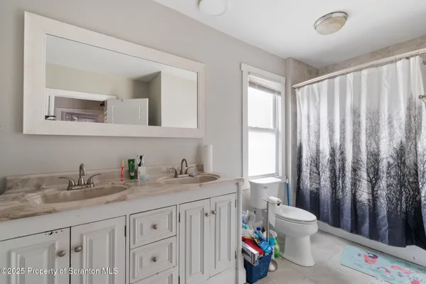 a view of a bathroom with sink bedroom and wooden floor