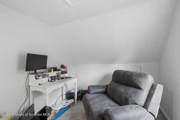 a bed room with a bed and a television