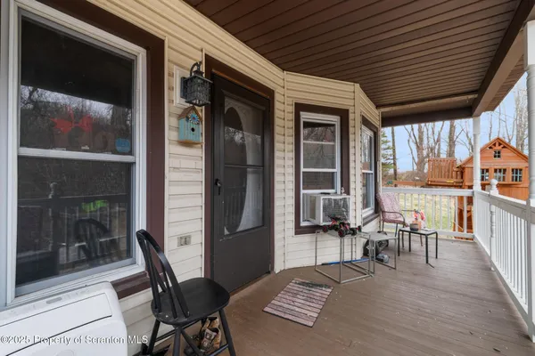 a view of a tables and chairs in back yard of the house