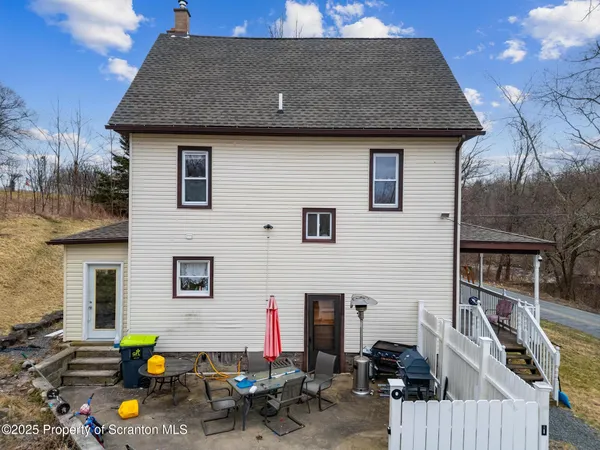 a front view of house with outdoor seating