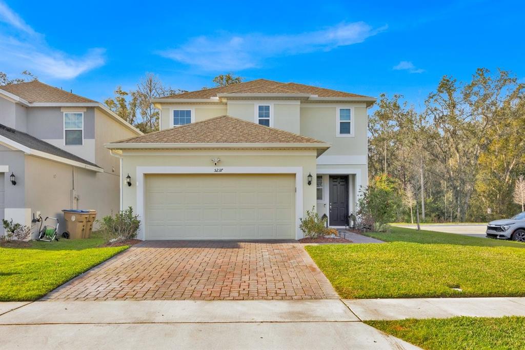 5237 Royal Point Avenue Kissimmee, FL 34746 - Photo 1 of 28 a front view of a house with a yard