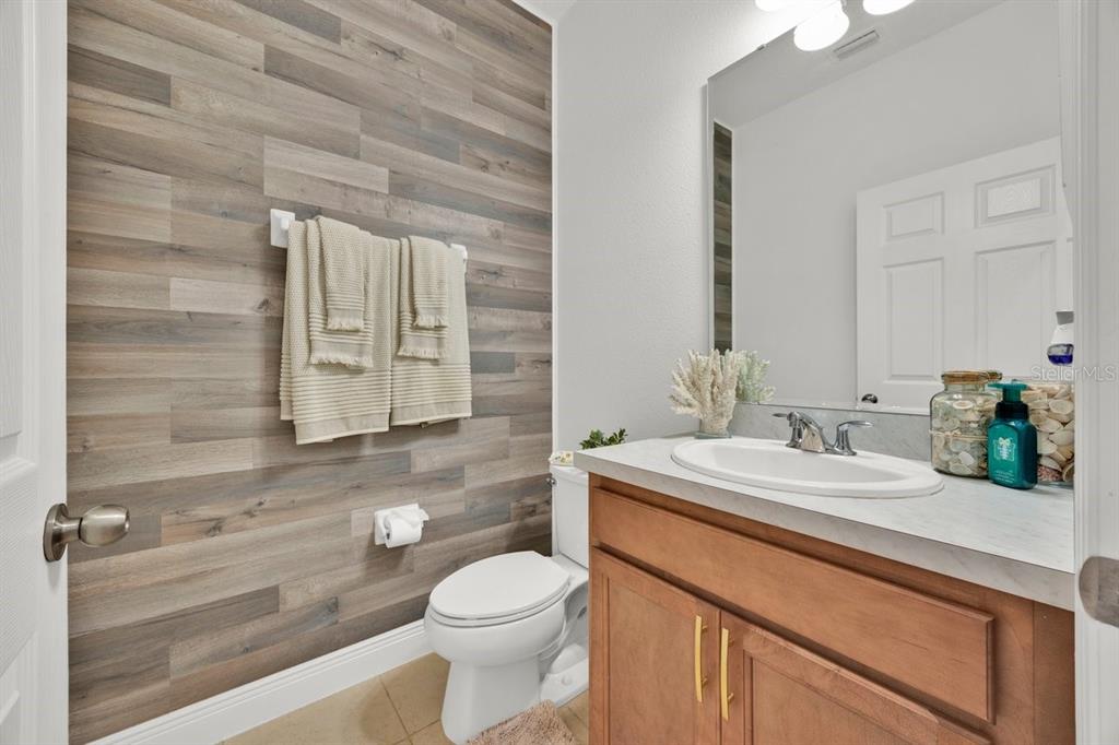 5237 Royal Point Avenue Kissimmee, FL 34746 - Photo 11 of 28 a bathroom with a sink a toilet and mirror