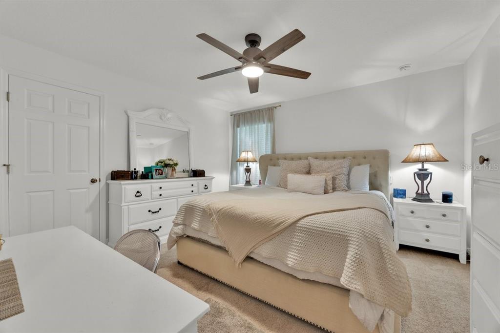 5237 Royal Point Avenue Kissimmee, FL 34746 - Photo 15 of 28 a bedroom with a bed and ceiling fan
